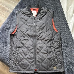 Size M. Men’s black quilted vest, with orange inside. From H&M.